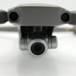 Dron z kamerą widziany od przodu na białym tle
